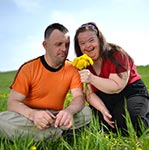 Lady with Downs Syndrome on a first date with a man, having fun.